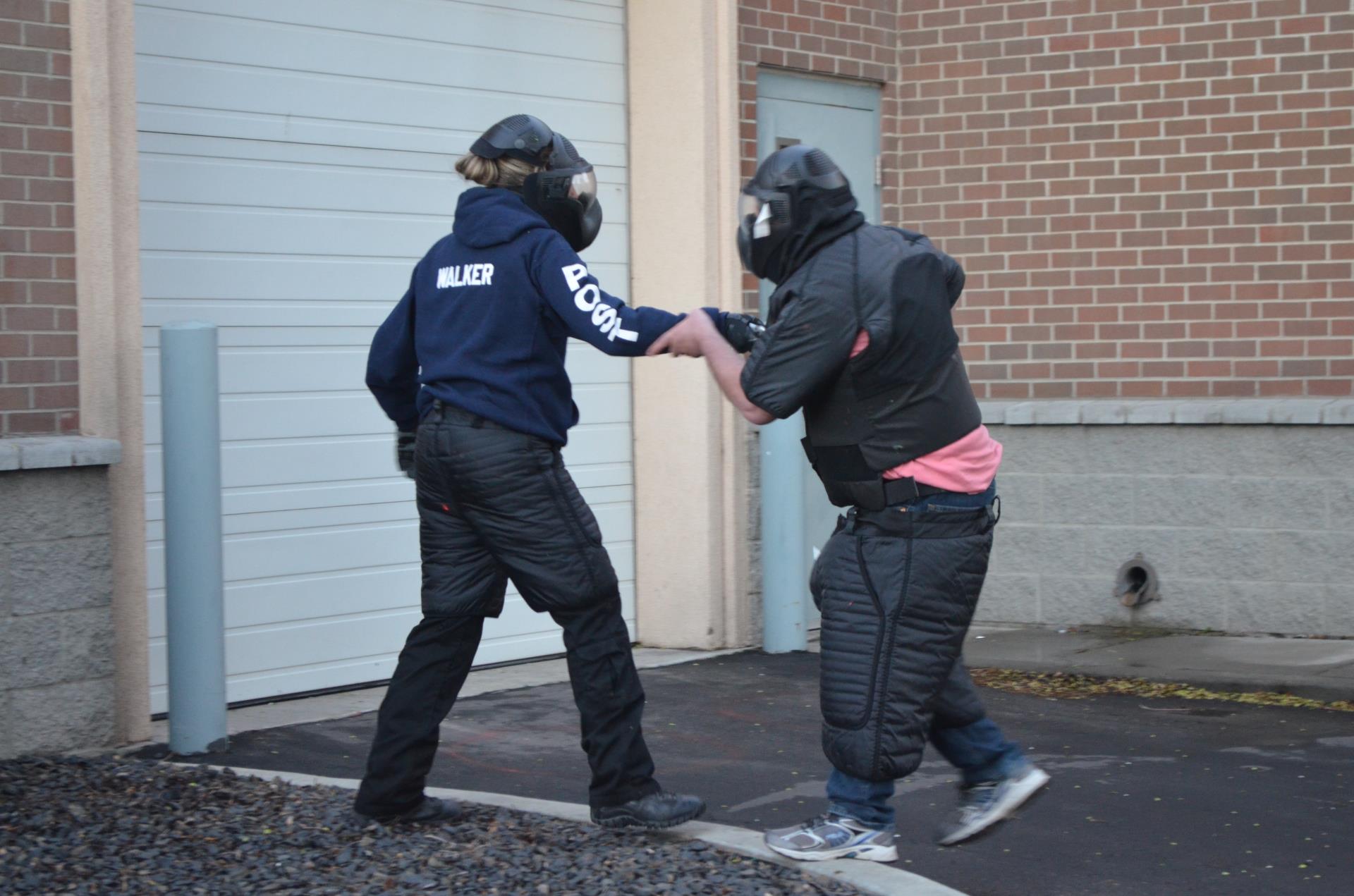 A student disarming a simulated suspect