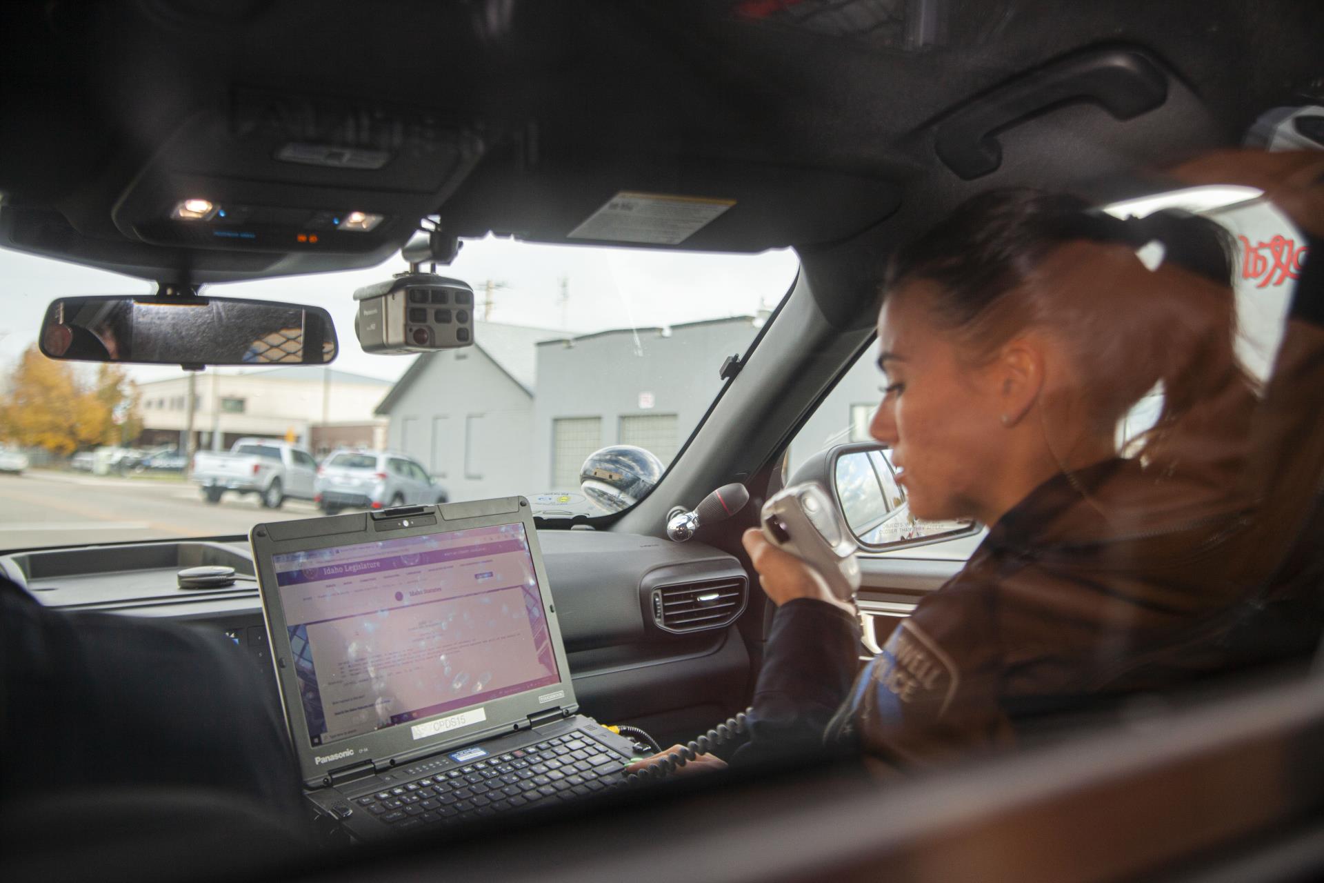 Female CPD Officer talking on the car radio